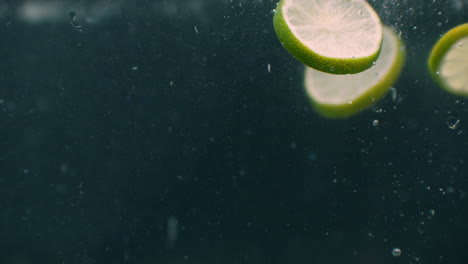 Limes-splashing-into-water-slow-motion.